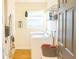 A clean laundry room with modern washer and dryer, overhead shelving, and ample lighting at 423 Midway Ave, Mascotte, FL 34753