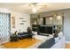 Open living space featuring a ceiling fan, decorations, desk, and a comfortable sectional sofa at 423 Midway Ave, Mascotte, FL 34753