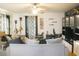 A comfortable living room area boasting a ceiling fan, modern decorations, and a spacious couch at 423 Midway Ave, Mascotte, FL 34753