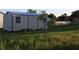 Backyard storage shed with a metal roof providing ample space for gardening equipment and tools at 423 Midway Ave, Mascotte, FL 34753