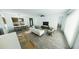 Spacious open concept living area with sleek furniture, plank flooring, and natural light at 4476 Sw 149Th St, Ocala, FL 34473