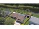 Aerial view of home with a private pool and fenced backyard with pond view at 4830 Red Bay Dr, Orlando, FL 32829