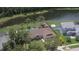 Aerial view of the property with a private pool, fenced yard, and pond view at 4830 Red Bay Dr, Orlando, FL 32829