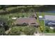 Aerial view of home with a private pool and fenced backyard with pond view at 4830 Red Bay Dr, Orlando, FL 32829