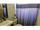 Bathroom featuring tile walls, a toilet, and decorative shower curtain at 4830 Red Bay Dr, Orlando, FL 32829