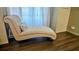 A chaise lounge by a window offers an elegant and comfortable retreat at 4830 Red Bay Dr, Orlando, FL 32829