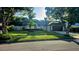 Beautifully landscaped home featuring a lush green lawn and mature trees on a sunny day at 4830 Red Bay Dr, Orlando, FL 32829