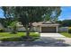 Charming single-story home featuring a well-manicured lawn and a large tree in the front yard at 4830 Red Bay Dr, Orlando, FL 32829