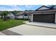 Well-maintained single-story home with an attached garage, a lush lawn, and mature trees at 4830 Red Bay Dr, Orlando, FL 32829