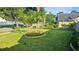 Lush front yard featuring a well-manicured lawn, landscaping, and mature shade trees at 4830 Red Bay Dr, Orlando, FL 32829