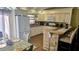 Bright kitchen featuring granite countertops, white cabinets, and adjoining dining area at 4830 Red Bay Dr, Orlando, FL 32829