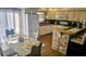 Bright kitchen features a breakfast bar with seating and dining table with gold chargers and modern cabinets at 4830 Red Bay Dr, Orlando, FL 32829