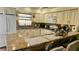 Bright kitchen featuring granite countertops, white cabinetry, and a breakfast bar at 4830 Red Bay Dr, Orlando, FL 32829