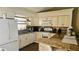 Bright kitchen featuring granite countertops, white cabinetry, and a breakfast bar at 4830 Red Bay Dr, Orlando, FL 32829