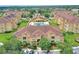 An aerial view of a residential community featuring a pool and manicured grounds at 504 Terrace Ridge # 311, Davenport, FL 33896