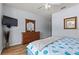 Bedroom with wood floors, dresser, and mounted flat screen TV at 504 Terrace Ridge # 311, Davenport, FL 33896