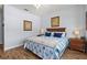 Comfortable bedroom featuring wood floors, nautical decor, and a plush queen-size bed at 504 Terrace Ridge # 311, Davenport, FL 33896