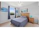Bright bedroom with neutral colors, featuring a bed, and blue accents at 504 Terrace Ridge # 311, Davenport, FL 33896