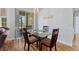 Inviting dining area with a glass table and wooden chairs, next to a sliding door at 504 Terrace Ridge # 311, Davenport, FL 33896