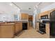 Well-equipped kitchen features essential appliances and ample storage, with a view to the laundry room at 504 Terrace Ridge # 311, Davenport, FL 33896