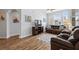 Comfortable living room with hardwood floors, couch, and entertainment center at 504 Terrace Ridge # 311, Davenport, FL 33896