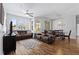 Spacious living room with dark floors, sofa, and TV, open to dining area at 504 Terrace Ridge # 311, Davenport, FL 33896