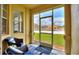 Enclosed porch with seating offering a view of the community pool and lawn at 504 Terrace Ridge # 311, Davenport, FL 33896