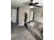 Cozy bedroom features neutral carpet, a ceiling fan, and two closets for ample storage at 5519 Braken Fern Way, Leesburg, FL 34748