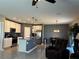 Modern kitchen features stainless steel appliances, a kitchen island, and an adjacent dining area at 5519 Braken Fern Way, Leesburg, FL 34748