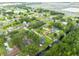 An aerial view of a neighborhood, featuring many houses with canals, interspersed with lush trees and landscaping at 6161 Bass Hwy, St Cloud, FL 34771