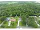 Lovely waterfront home features a long driveway and a backyard pool and deck surrounded by mature trees at 6161 Bass Hwy, St Cloud, FL 34771