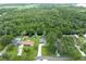 An aerial view showcases the property and its neighborhood with lush greenery and a private swimming pool at 6161 Bass Hwy, St Cloud, FL 34771