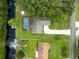 Aerial view of a backyard with screened in pool, dock, and boat on canal at 6161 Bass Hwy, St Cloud, FL 34771