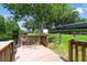 Inviting wooden dock with railing on the water, offering a tranquil spot by the canal at 6161 Bass Hwy, St Cloud, FL 34771