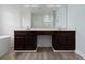 Double sink bathroom vanity features modern faucets and a large mirror at 6905 Beargrass Rd, Harmony, FL 34773