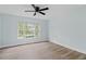 Bedroom featuring wood-look floors and a window with a view of the outdoors at 6905 Beargrass Rd, Harmony, FL 34773