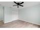 Light bedroom with wood-look flooring, closet with bi-fold doors, and fresh light-colored paint at 6905 Beargrass Rd, Harmony, FL 34773