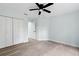 Spacious bedroom with wood-look flooring, ceiling fan, and a closet at 6905 Beargrass Rd, Harmony, FL 34773