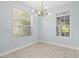 Cozy dining area illuminated by a modern light fixture and natural light at 6905 Beargrass Rd, Harmony, FL 34773