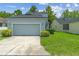 Exterior view of the home showing the front facade, garage, driveway, and lawn at 6905 Beargrass Rd, Harmony, FL 34773