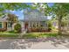 Charming two-story home featuring a welcoming front porch and lush landscaping at 6905 Beargrass Rd, Harmony, FL 34773