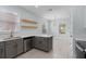 Modern kitchen features stylish gray cabinets and a breakfast bar at 6905 Beargrass Rd, Harmony, FL 34773