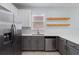 Kitchen featuring stainless steel appliances and open wooden shelving at 6905 Beargrass Rd, Harmony, FL 34773