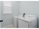 A clean and functional laundry room with side by side washer and dryer at 6905 Beargrass Rd, Harmony, FL 34773