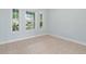 Bright living room featuring large windows and neutral tile flooring at 6905 Beargrass Rd, Harmony, FL 34773