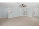 Spacious living room with neutral tile flooring, ceiling fan and easy access to other rooms at 6905 Beargrass Rd, Harmony, FL 34773