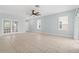 Open living room showcasing tile floors, ceiling fan, and plenty of natural light at 6905 Beargrass Rd, Harmony, FL 34773