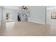 Bright, open-concept living room featuring neutral tile flooring and natural light at 6905 Beargrass Rd, Harmony, FL 34773