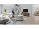 Bright living room with tile floors, ceiling fan, and sliding glass doors to the outdoors at 6905 Beargrass Rd, Harmony, FL 34773