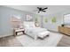 Stylishly furnished main bedroom with neutral tones, a ceiling fan, and three windows at 6905 Beargrass Rd, Harmony, FL 34773